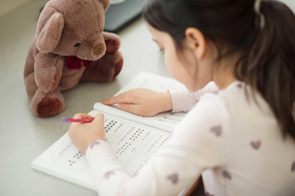 A child working on a paper